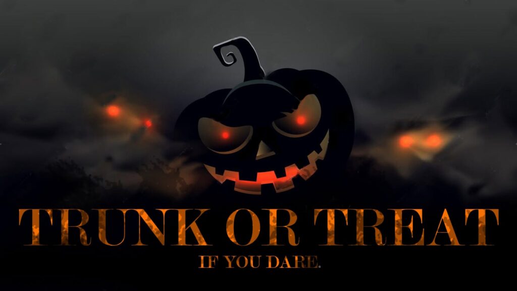 black smiling pumpkin on a dark background with the words trunk or treat if you dare at the bottom.